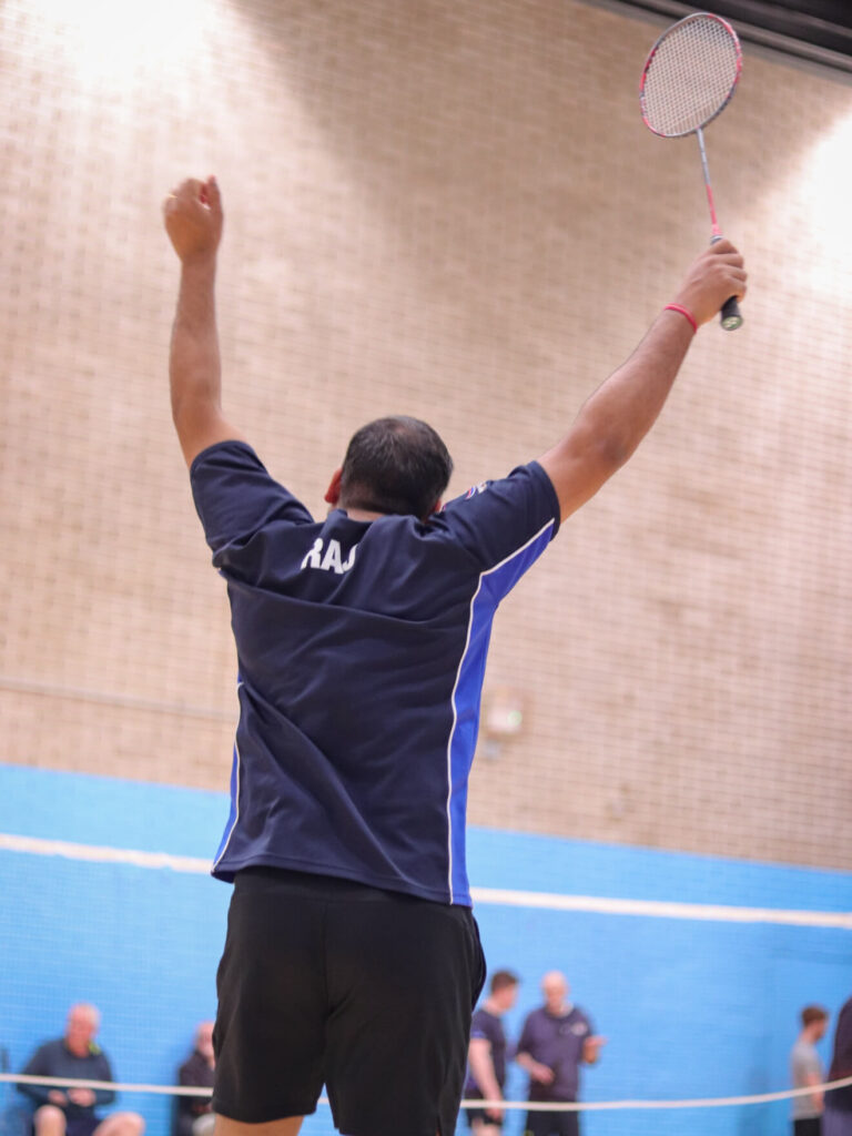 Badminton sports player celebrating a winning game of LGBT+ badminton